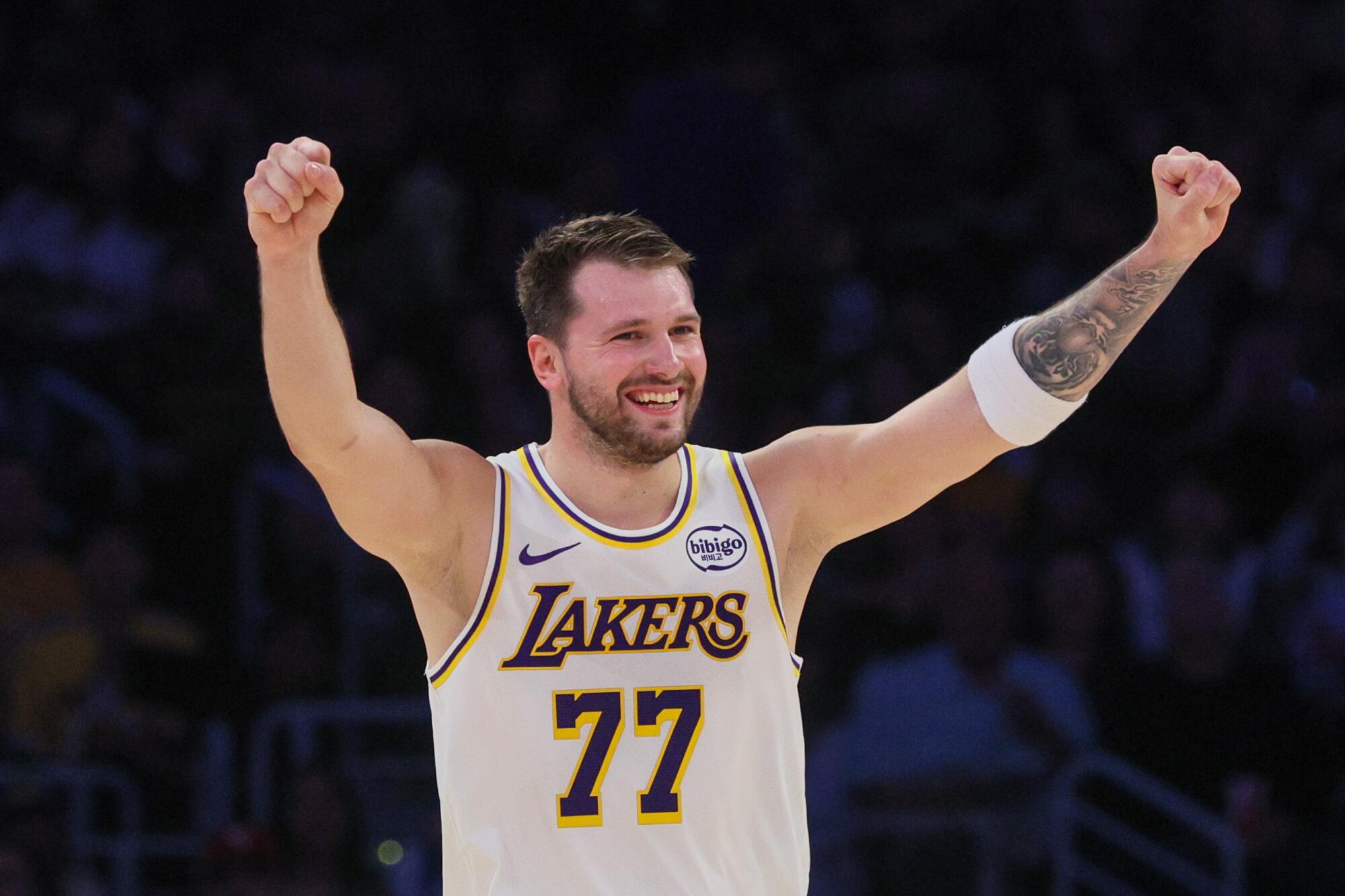 Lakers star Luka Doncic celebrates after a three-pointer by teammate Rui Hachimura.