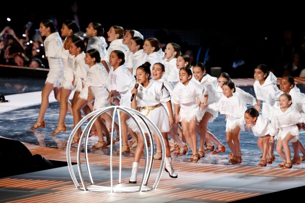 Emme Maribel Muñiz, daughter of singer Jennifer Lopez, performs with other children by a cage during the halftime show of the NFL Super Bowl 54 football game in Miami Gardens, Fla, on Feb. 2, 2020. (AP Photo/Tyler Kaufman, File)