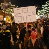 A person holds a sign during a vigil for 37-year-old Alex Pretti, who was fatally shot by a U.S. Border Patrol officer earlier in the day, on Saturday in Minneapolis. 