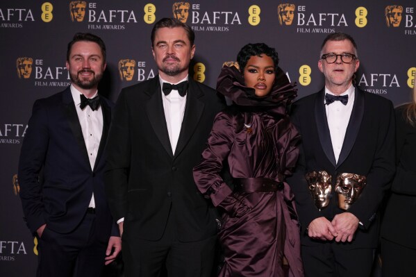 Andy Jurgensen, from left, Leonardo DiCaprio, Teyana Taylor, and Paul Thomas Anderson pose with the awards for best director, cinematography, and adapted screenplay for 'One Battle After Another' at the 79th British Academy Film Awards, BAFTA's, in London, Sunday, Feb. 22, 2026. (AP Photo/Alastair Grant)