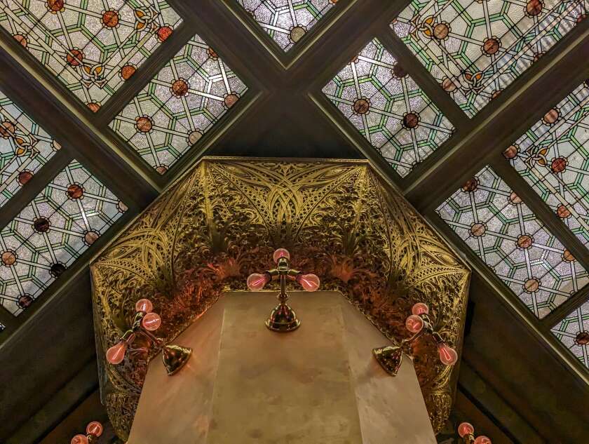 An ornate column capitals and an art glass ceiling