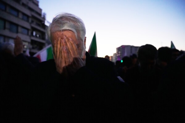 A government supporter mourns during a gathering after state television officially announced the death of Iranian Supreme Leader Ayatollah Ali Khamenei, in Tehran, Iran, Sunday, March 1, 2026. (AP Photo/Vahid Salemi)