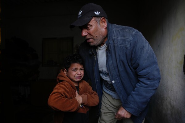 Yazid Al-Zayan, 9, mourns during the funeral for his father, Khaled Al-Zayan, a Palestinian policeman, who was killed in an Israeli military strike, in Khan Younis, southern Gaza Strip, Friday, Feb. 27, 2026. (AP Photo/Abdel Kareem Hana)