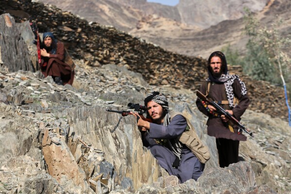 Afghan Taliban soldiers look toward the Pakistani side, on the Afghan side of the Torkham border crossing with Pakistan in Torkham, Afghanistan, Friday, Feb. 27, 2026. (AP Photo/Wahidullah Kakar)