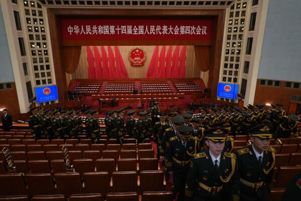 Military delegates assemble before the opening session of the National People's Congress (NPC) in Beijing, Thursday, March 5, 2026. (AP Photo/Ng Han Guan)