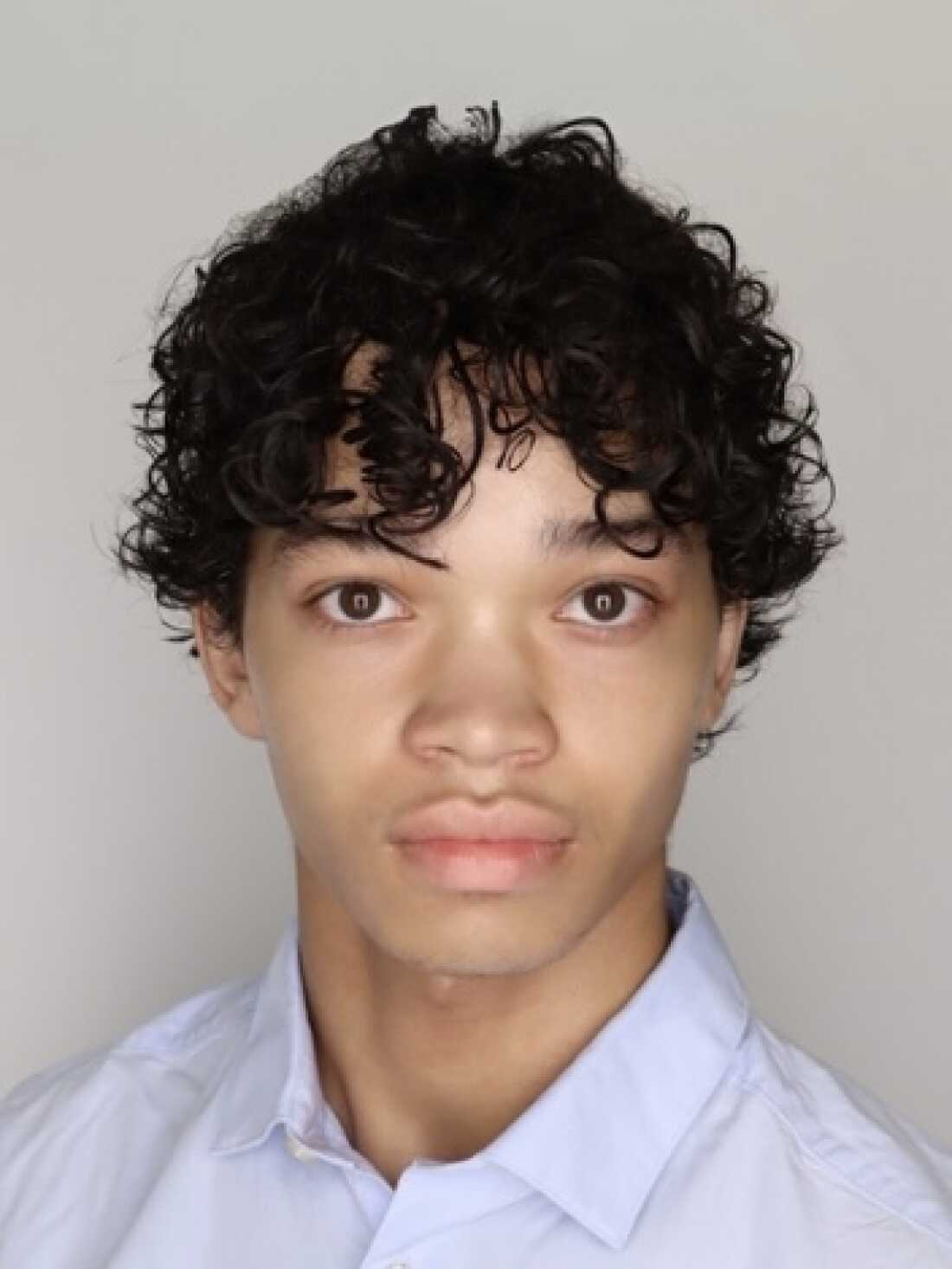 A photo of Maximilian Milovidov showing him from about the shoulders up.