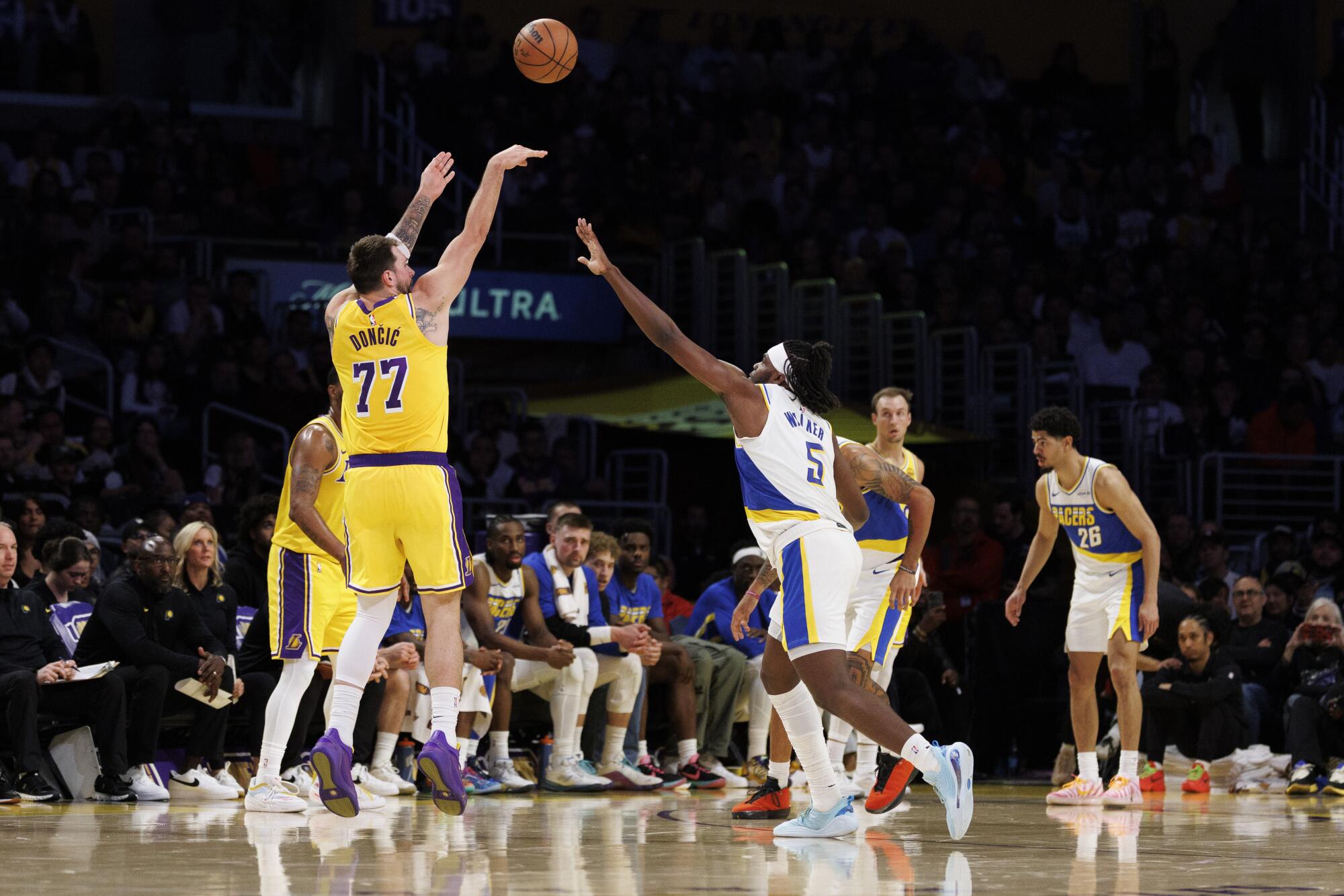 Luka Doncic shoots a three-pointer over Indiana Pacers forward Jarace Walker in the first half Friday.
