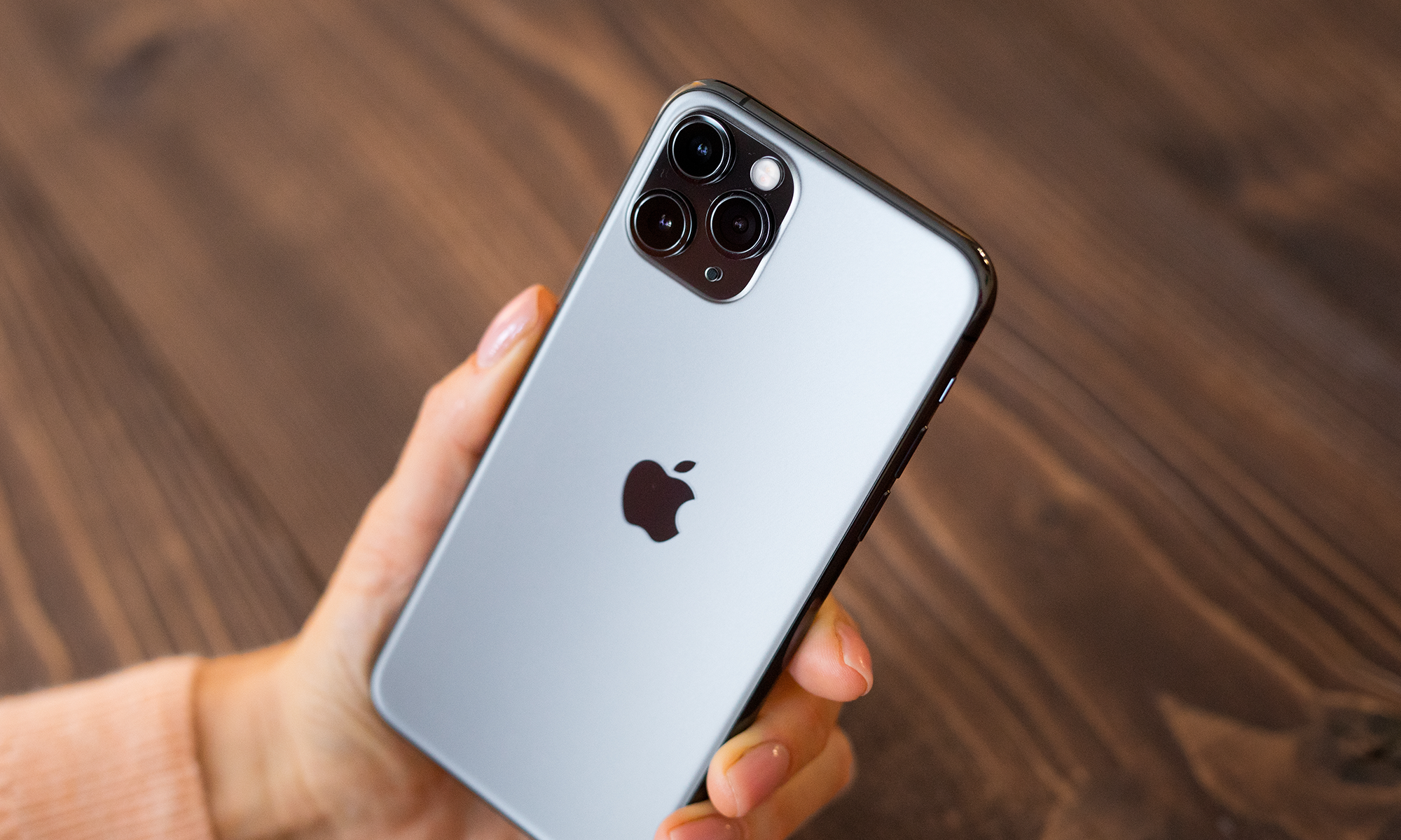 Hand holding an Apple iPhone.