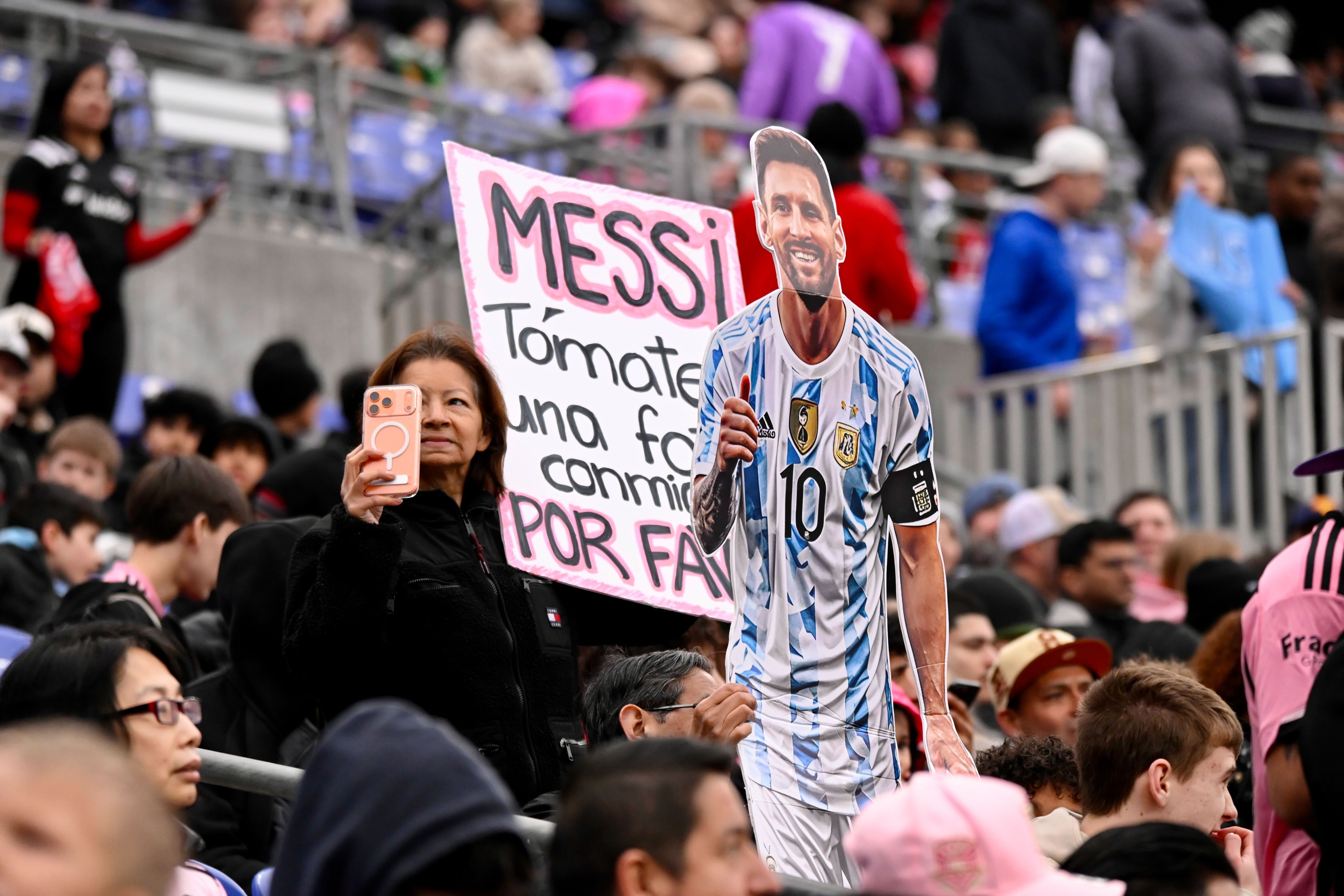 Fans show their support for soccer star Lionel Messi during...