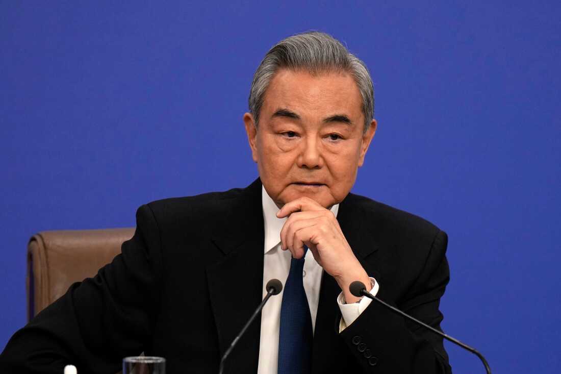 Chinese Foreign Minister Wang Yi listens during a press conference on the sideline of the National People's Congress (NPC) at the media center in Beijing, Sunday, March 8, 2026.