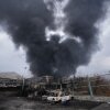 A thick plume of smoke rises from an oil storage facility hit by a U.S.-Israeli strike late Saturday in Tehran, Iran, Sunday, March 8, 2026.