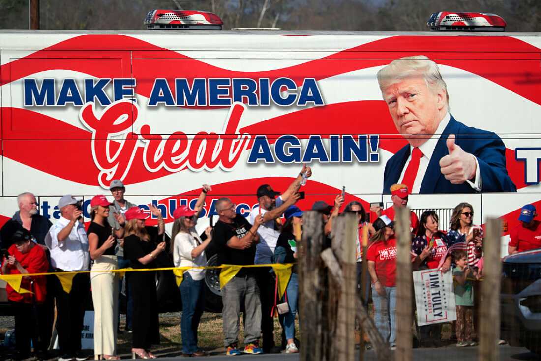 People cheer for President Trump en route to his speaking engagement at the Coosa Steel Corporation on Feb. 19 in Rome, Ga. Trump delivered remarks on the economy and affordability as the state started voting to replace the seat vacated by former Republican Rep. Marjorie Taylor Greene.