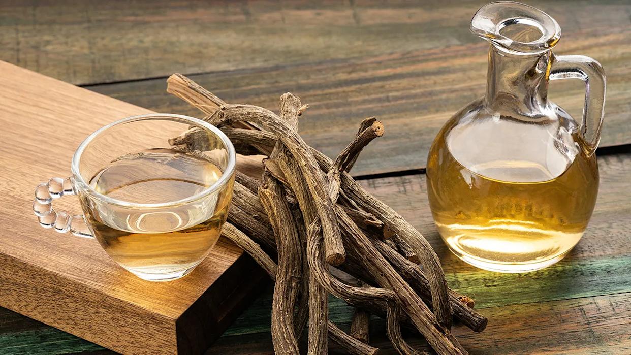 valerian roots in between a tea cup and oil glassware