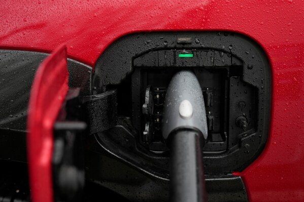 An electric vehicle charges at a station Wednesday, March 11, 2026, in Lincolnwood, Ill. (AP Photo/Erin Hooley)