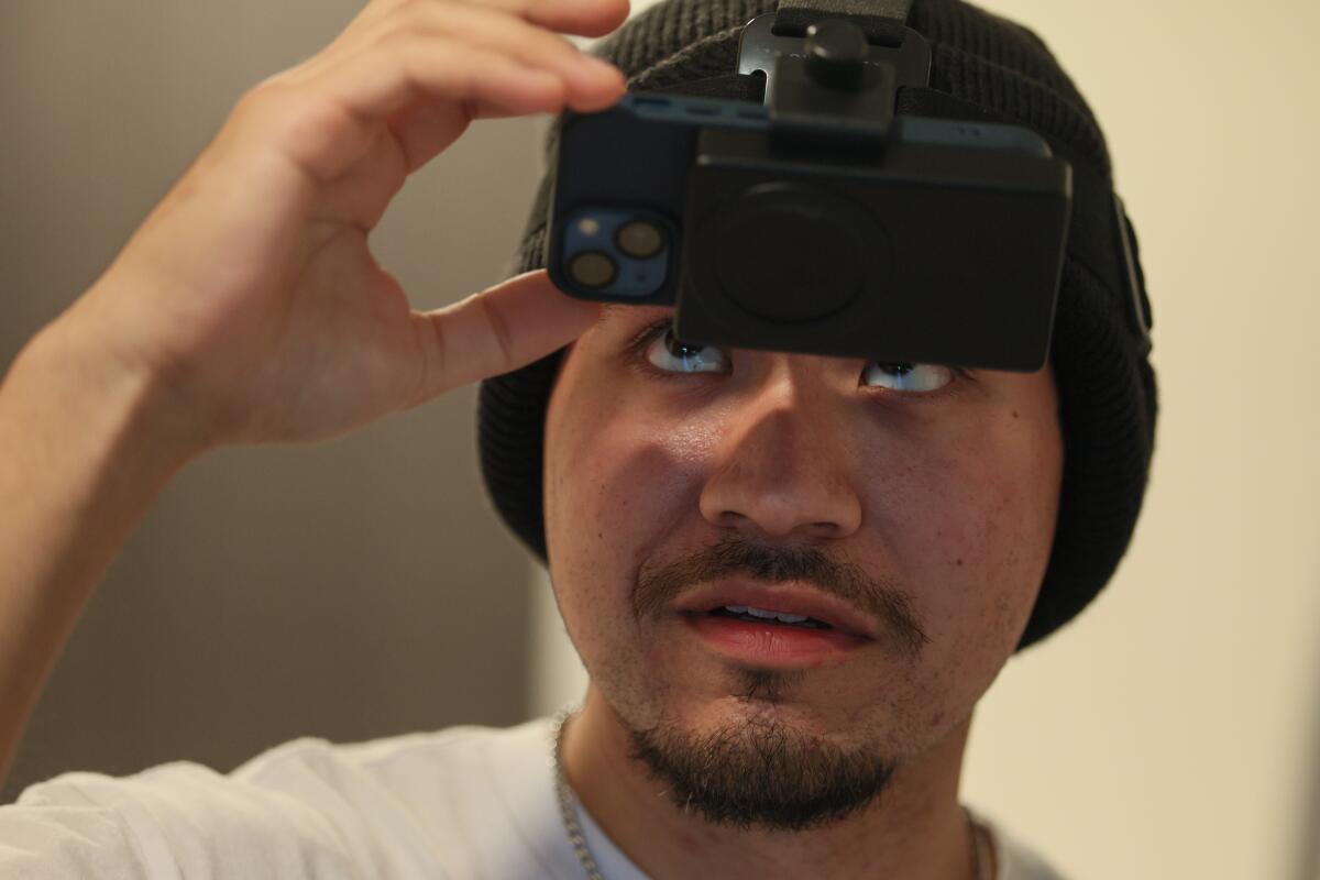 Arciga adjusts the headset to record himself doing housework