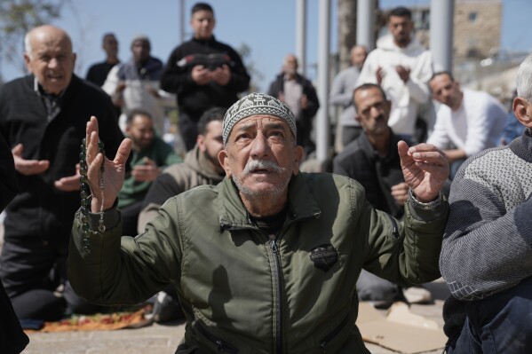 Palestinian Muslims offer Friday Ramadan prayers in Jerusalem on Friday, March 6, 2026, as the Old City remains closed to visitors under nationwide Home Front Command restrictions banning large gatherings amid the war with Iran. (AP Photo/Mahmoud Illean)