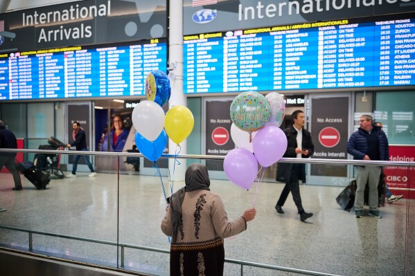 Aqlima Amini waits for her family to arrive from Dubai at Pearson Airport in Toronto, on Saturday, March 7, 2026. Onboard the flight were at least 50 Canadians that booked seats with the assistance of Global Affairs Canada, as the government helps Canadians leave the Mideast amid escalating violence. (Sammy Kogan/The Canadian Press via AP)