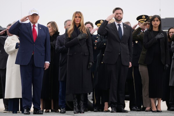 From left, President Donald Trump, first lady Melania Trump, Vice President JD Vance and his wife, Usha Vance, attend a casualty return for the soldiers who were killed in a drone strike at a command center in Kuwait after the U.S. and Israel launched its military campaign against Iran, Saturday, March 7, 2026, at Dover Air Force Base, Del. (AP Photo/Mark Schiefelbein)