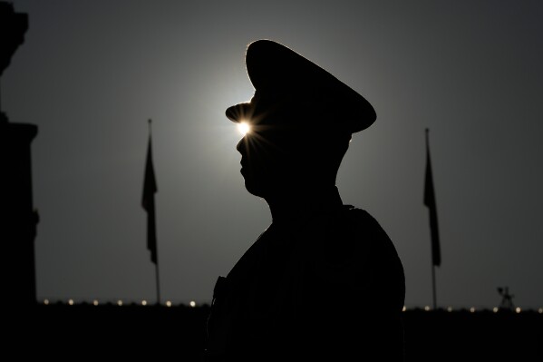 A paramilitary police officer stands guard in Tiananmen Square before a plenary session of the National People's Congress (NPC) is held at the Great Hall of the People in Beijing, Monday, March 9, 2026. (AP Photo/Ng Han Guan)