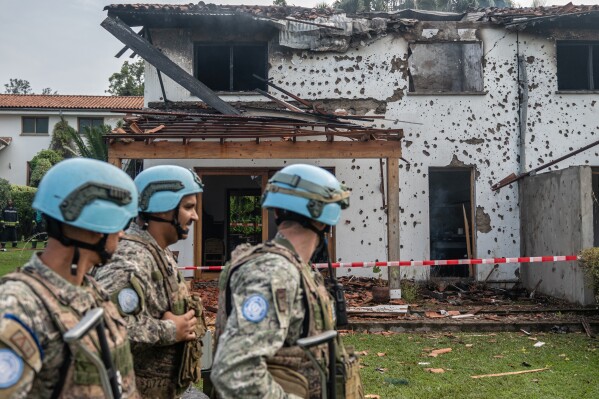 U.N peacekeepers guard a house hit by a drone strike in Goma, Democratic Republic of Congo, Wednesday, March 11, 2026. (AP Photo/Moses Sawasawa)