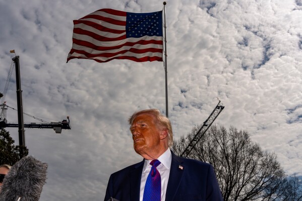 President Donald Trump speaks with reporters before departing on Marine One from the South Lawn of the White House, Wednesday, March 11, 2026, in Washington. (AP Photo/Alex Brandon)