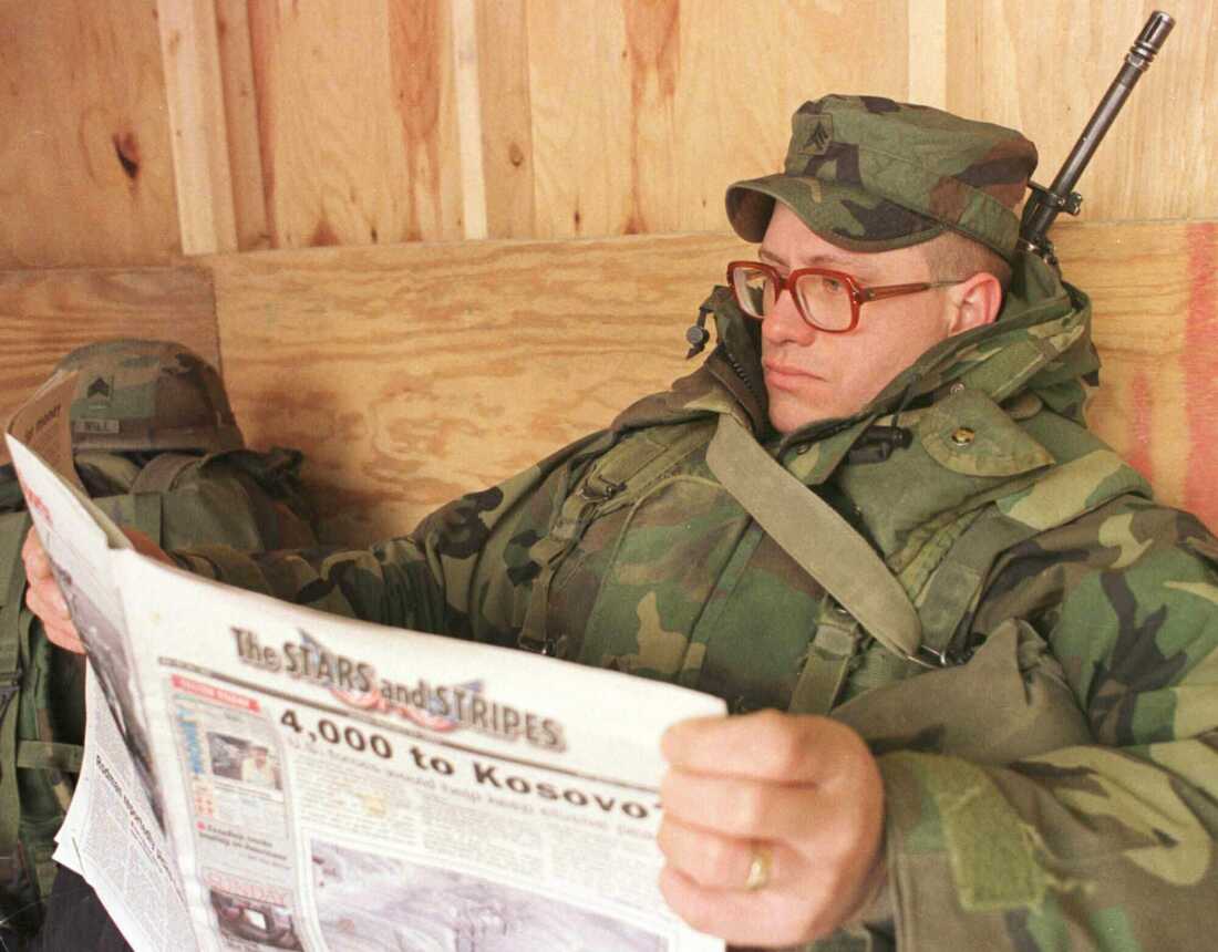 US soldier Sgt. John Hubbuch of Versailles, Ky., one of the members of NATO led-peacekeeping forces in Bosnia reads Stars and Stripes newspaper on Sunday Feb. 14, 1999. (AP Photo/Amel Emric, File)