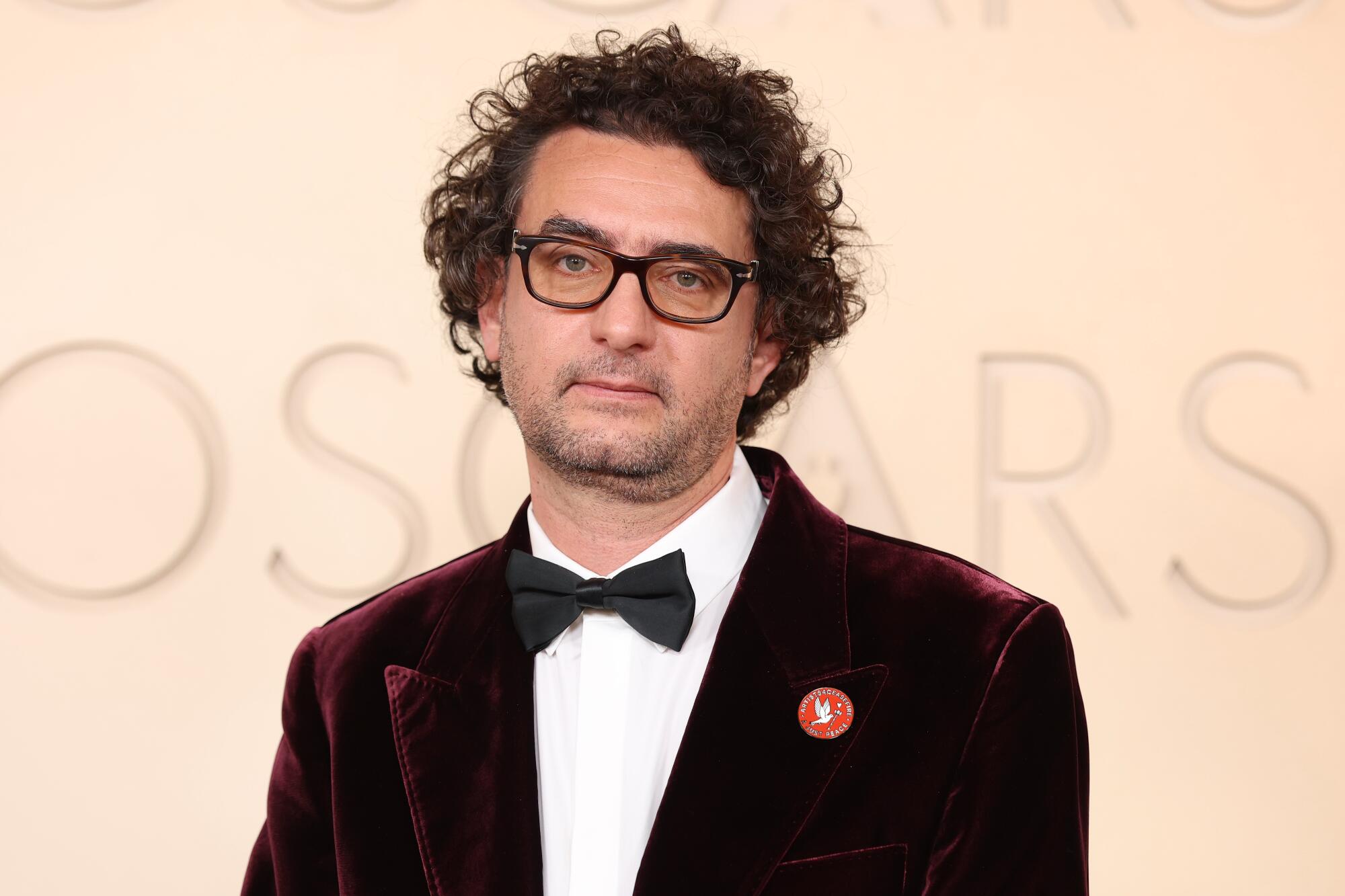 Nadim Cheikhrouha wears an Artists4Ceasefire pin.