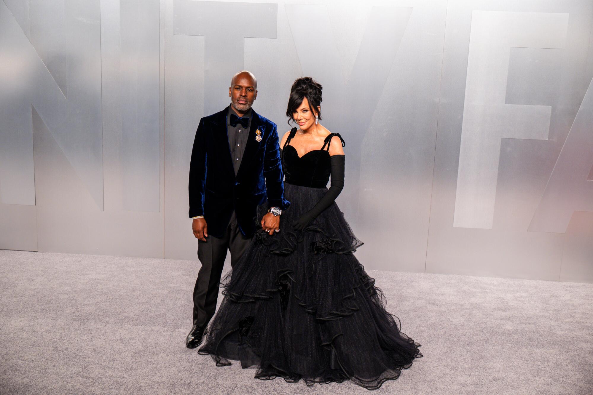 Corey Gamble and Kris Jenner hold hands on the red carpet. 