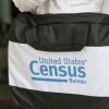The U.S. Census Bureau’s logo is featured on a black bag carried by a census worker knocking on doors in 2020 in Winter Park, Florida.