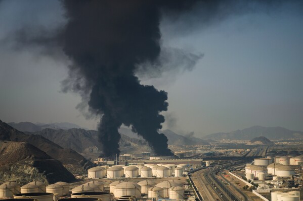 Plumes of smoke rise from an oil facility in Fujairah, United Arab Emirates, Saturday, March 14, 2026. (AP Photo/Altaf Qadri)