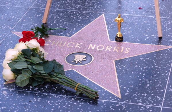 A toy Oscar is left on the Hollywood Walk of Fame star of the late actor Chuck Norris, who died Thursday at 86, Friday, March 20, 2026, in Los Angeles. (AP Photo/Chris Pizzello)