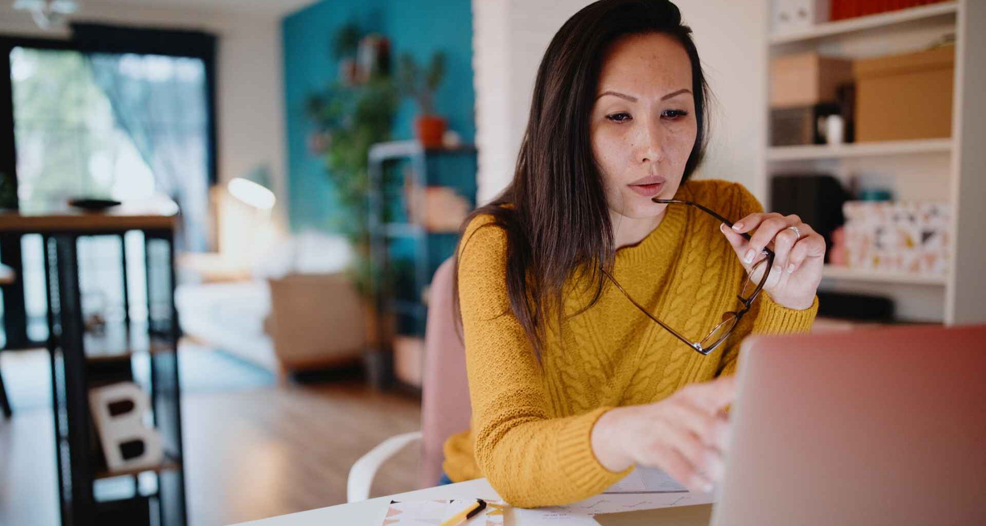 Middle aged woman working from home office.