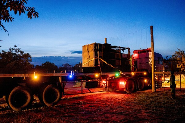 A truck carrying a rhinoceros in a transportation crate arrives at Kidepo Valley National Park in north-eastern Uganda, Tuesday, March 17, 2026. (AP Photo/Moses Dipak)