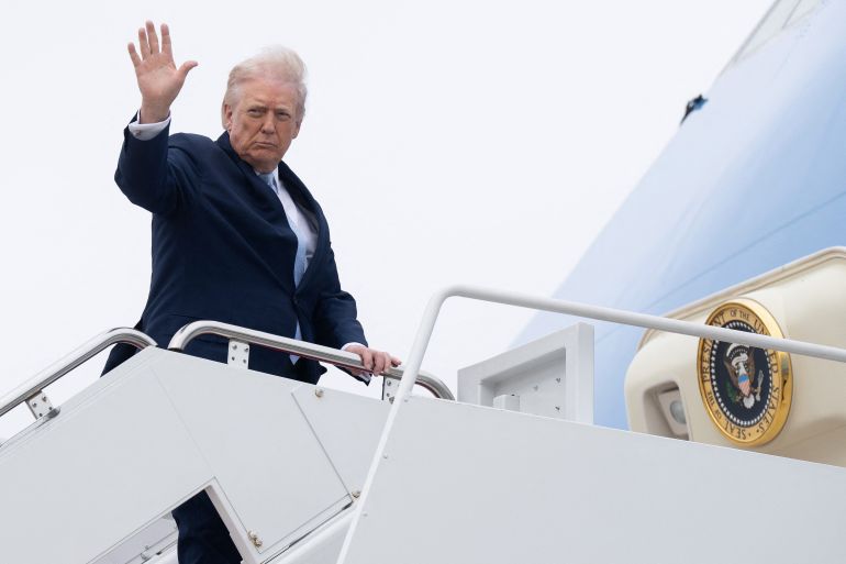 US President Donald Trump waves while boarding Air Force One at Joint Base Andrews in Maryland on March 20, 2026, before departing for his Mar-a-Lago residence in Florida, where he will spend the weekend.