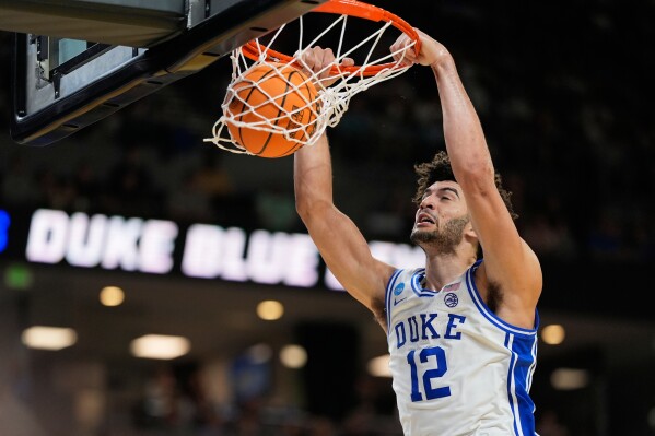 Duke forward Cameron Boozer dunks against TCU during the second half in the second round of the NCAA college basketball tournament, Saturday, March 21, 2026, in Greenville, S.C. (AP Photo/Chris Carlson)