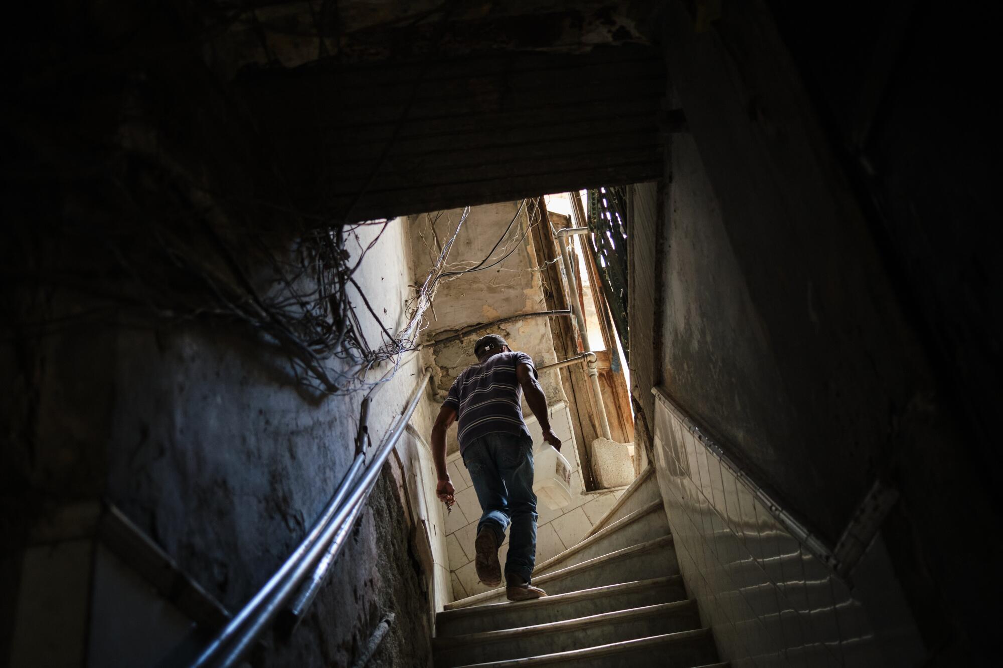 A man climbs a steep flight of stairs.