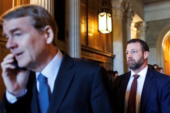 Sen. Markwayne Mullin, R-Okla., exits the Senate Chamber following a vote on Capitol Hill on Saturday, March 21, 2026, in Washington. (AP Photo/Tom Brenner)