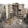 An excavator clears rubble from destroyed residential buildings in northern Tehran, Iran, on Monday, as the U.S. and Israel's war with Iran raged for its fourth week.