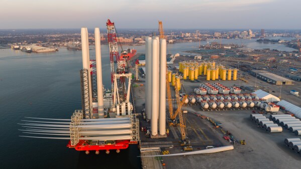 A construction barge is loaded at the Dominion Energy Offshore Wind Farm staging area at the Portsmouth Marine terminal Feb. 11, 2026, in Portsmouth, Va. (AP Photo/Steve Helber, File)