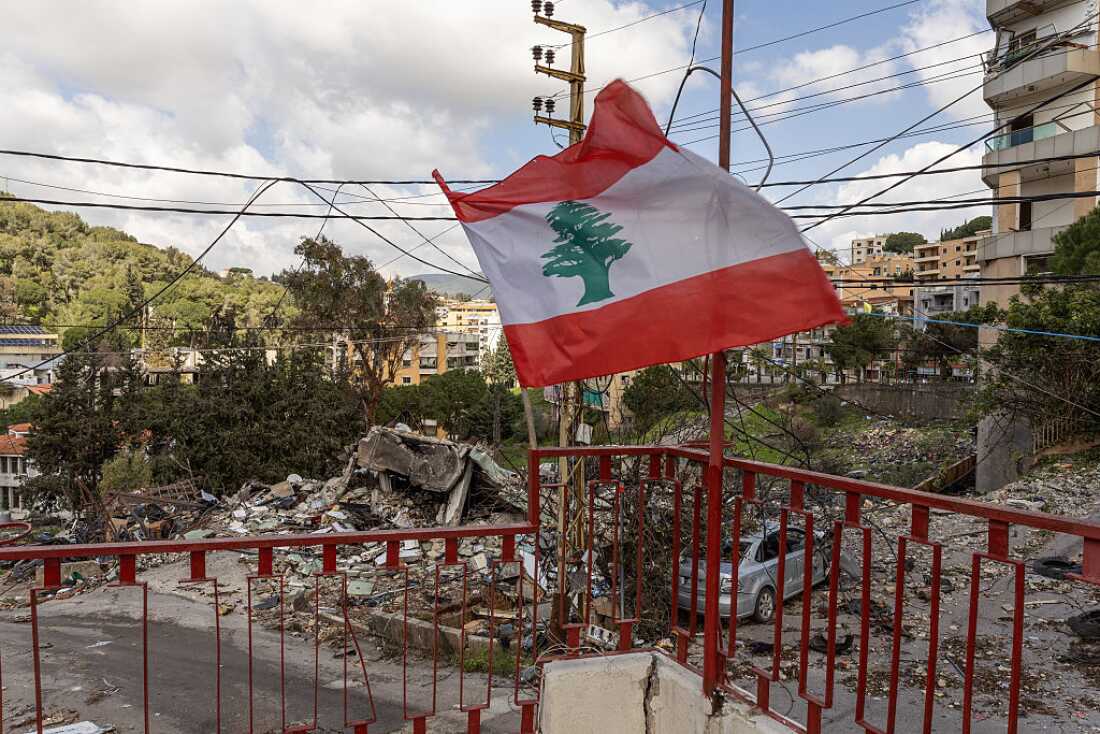 The Lebanese flag is waved amid the rubble of a Lebanese Civil Defence post destroyed in an IDF airstrike in Nabatiyeh, Lebanon, on March 24, 2026.