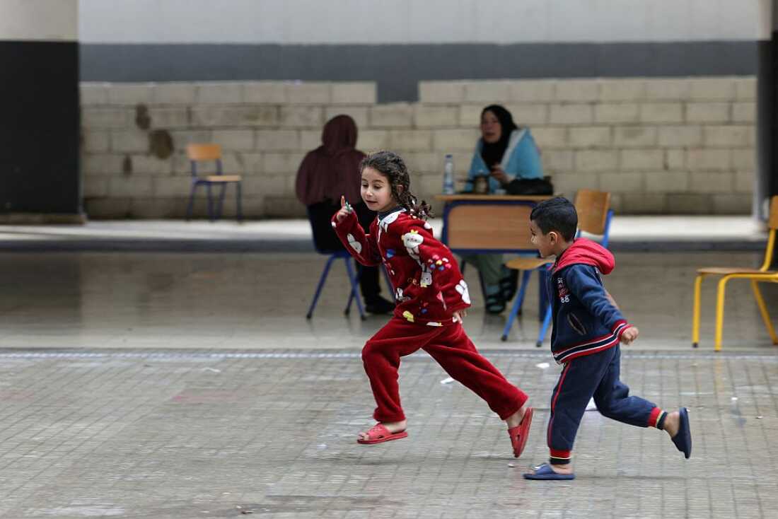 Displaced Lebanese children play in the playground of a public school that has been converted into a shelter in the town of Dekwaneh, north of Beirut, on March 25, 2026.