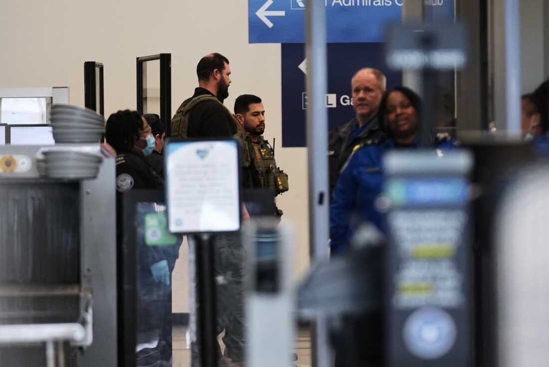 Immigration and Customs Enforcement agents work at the baggage check and security control x-ray area at O'Hare International Airport in Chicago on Tuesday.