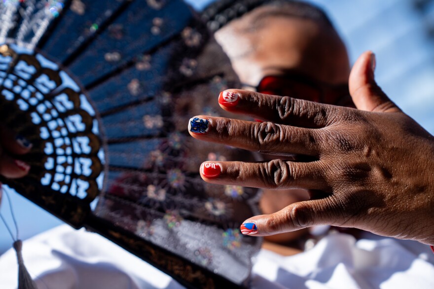 Chiquita Mewman, of Northwoods, shows off her St. Louis Cardinals-themed nails during MLB Opening Day festivities on Thursday, March 26, 2026, in downtown St. Louis.