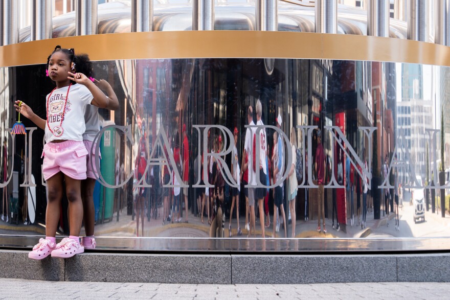 Khy’li Lambert, 4, has her photo made at a replica of the Worlds Series trophy during MLB Opening Day festivities on Thursday, March 26, 2026, in downtown St. Louis.