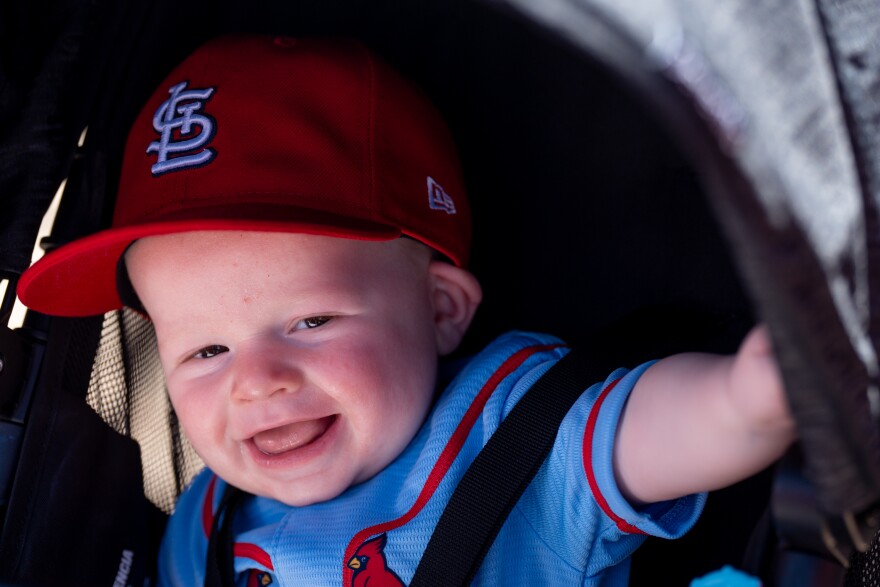 Maxwell Bulte-Trail, the St. Louis Cardinals’ 5 1/2-month-old fan, celebrates his first MLB Opening Day before the Cardinals take on the Tampa Bay Rays on Thursday, March 26, 2026, in downtown St. Louis.