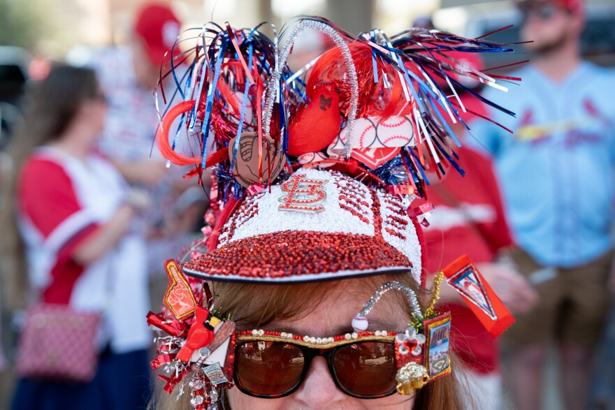 Diane Miller, of Ste. Genevieve, left, raises her arms during MLB Opening Day festivities at Ballpark Village on Thursday, March 26, 2026, in downtown St. Louis.
