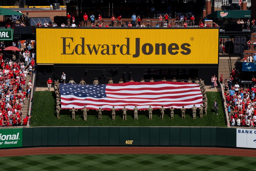 The American flag flies during the National Anthem as the St. Louis Cardinals takes on the Tampa Bay Rays during MLB Opening Day at Busch Stadium on Thursday, March 26, 2026, in downtown St. Louis.