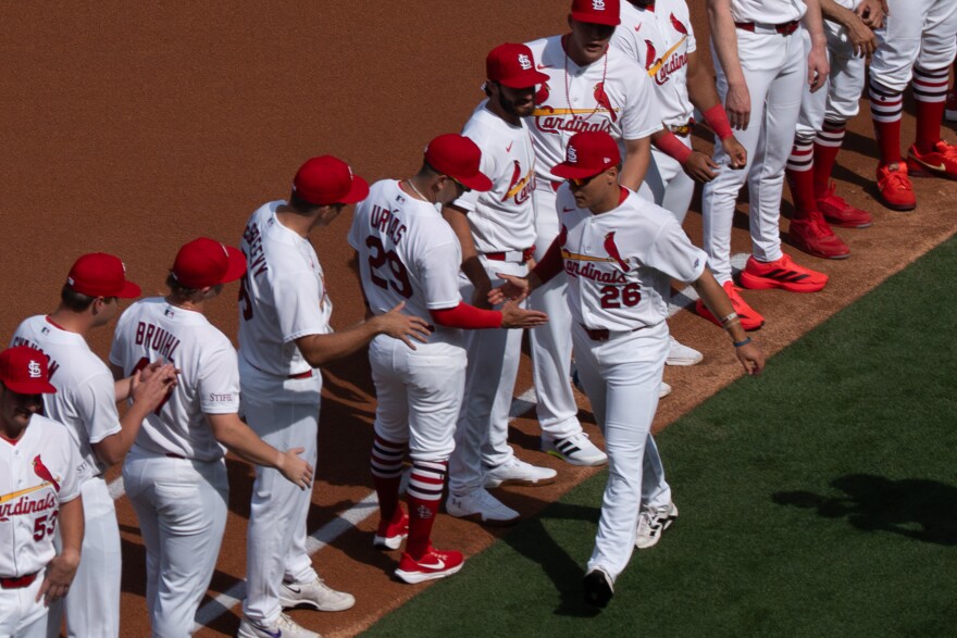 St. Louis Cardinals’ infielder JJ Wetherholt (26) high-fives teammates as he’s introduced before taking on the Tampa Bay Rays during MLB Opening Day on Thursday, March 26, 2026, in downtown St. Louis.