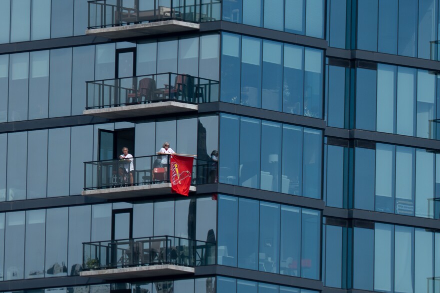St. Louis Cardinals fans watch the team from the One Cardinal Way apartment complex as the team takes on the Tampa Bay Rays during MLB Opening Day on Thursday, March 26, 2026, in downtown St. Louis.