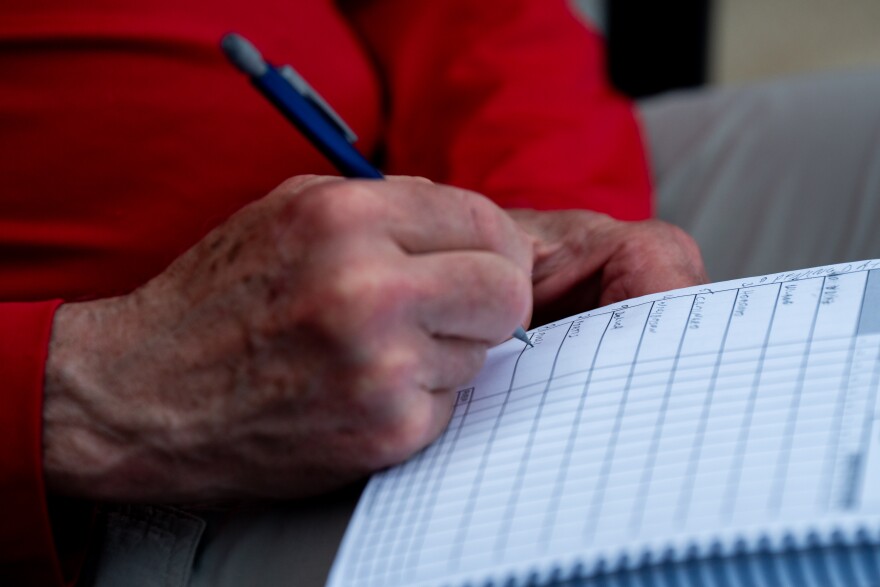 A St. Louis Cardinals fans writes down the starting lineup as the team takes on the Tampa Bay Rays during MLB Opening Day at Busch Stadium on Thursday, March 26, 2026, in downtown St. Louis.